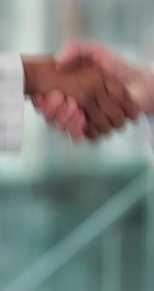 Doctors, handshake and agreement in hospital, lobby and thanks with welcome for hiring