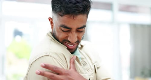 Man Experiencing Shoulder Pain Close Up Indoors