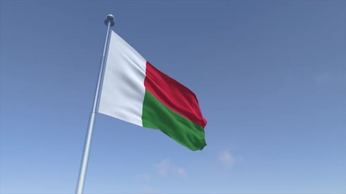 Madagascar Flag Waving in the Wind Against Blue Sky