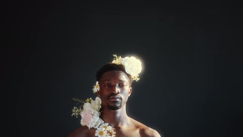 Man Adorned With White Flowers Poses With Confidence