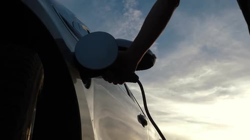 Electric Car Being Unplugged Outdoors