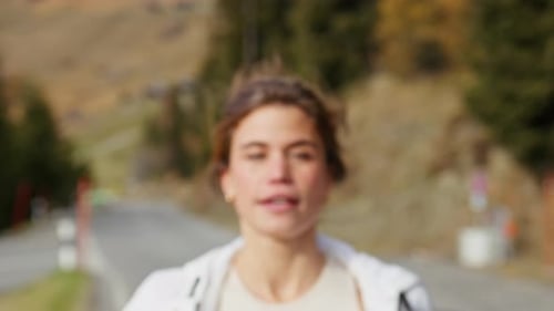 Woman running in the Swiss Alps in scenic alpine landscape