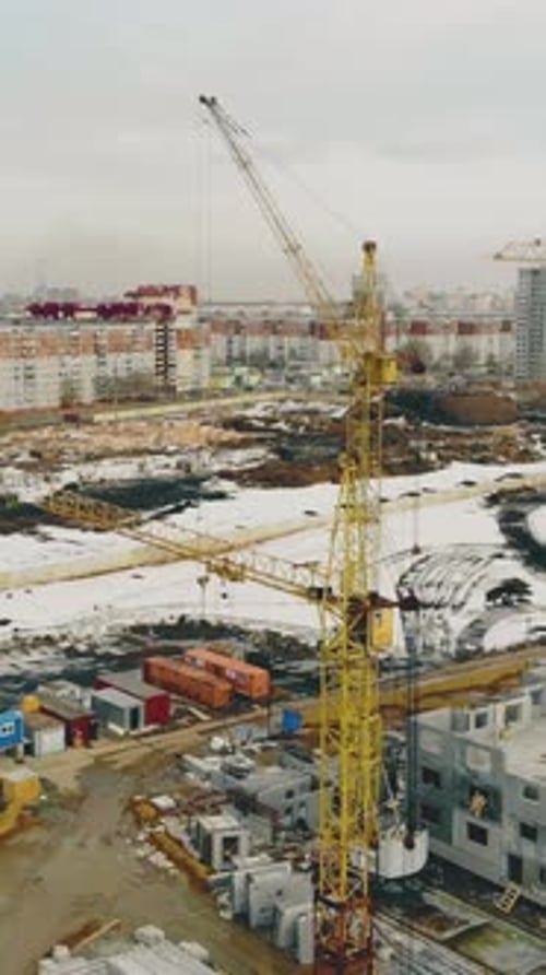 Yellow Building Cranes Located in Row on Construction Site