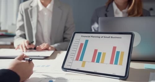 Financial Planning Meeting With Charts and Data