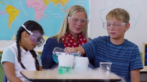 Teacher Doing Science Experiment with Students in School Classroom Boy