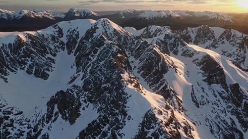 Snow Capped Mountains Aerial at Sunset