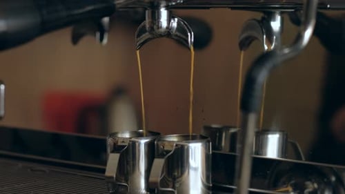 Coffee machine. Pouring coffee into cups close-up