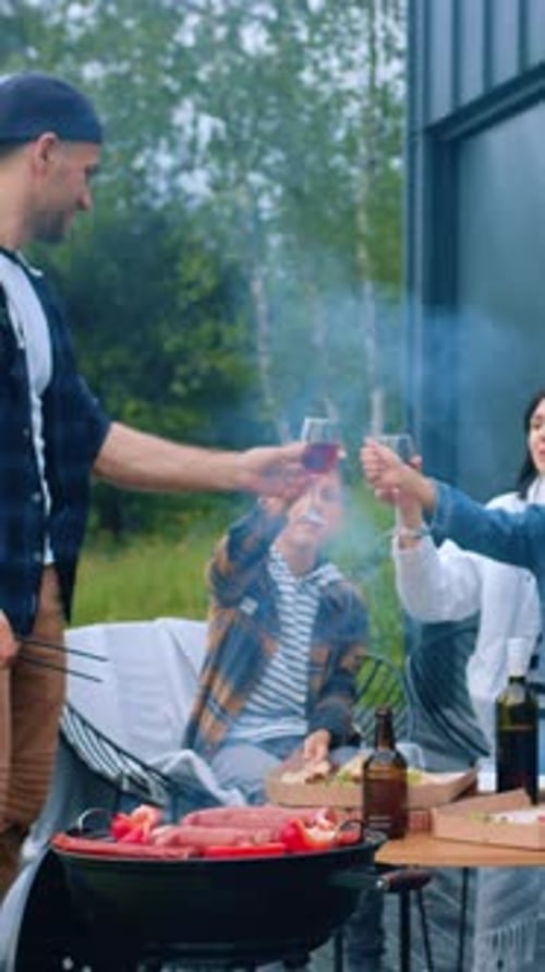 Family Barbecue Fun: Dad Grills, Toasting Drinks