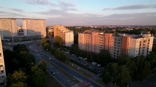 Aerial rising over Cracow city downtown at sunrise revealing an amazing skyline with purple clouds