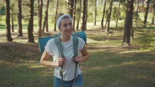 Woman Young Tourist with Backpack Walking in the Fall Forest on Sunny Summer Day Smile Look Around