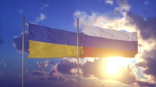 Ukraine and Russia Flags Waving at Sunset
