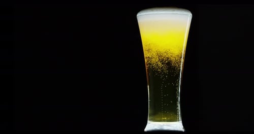 Glass of Refreshing Beer with Bubbles on Black