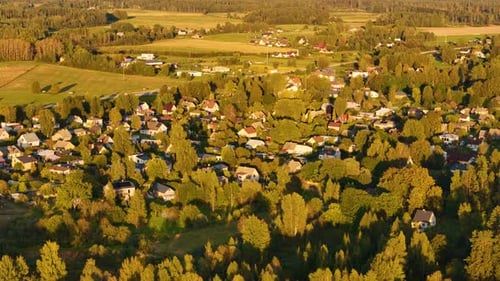 Rural small town around green rural forested area Aerial drone establishing shot of countryside loca