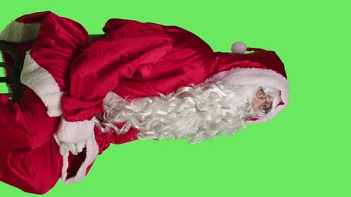 Side View of Man Dressed As Santa Claus on Chair Sitting