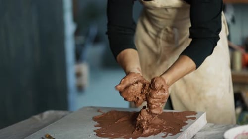 Artist Working Brown Clay in Studio