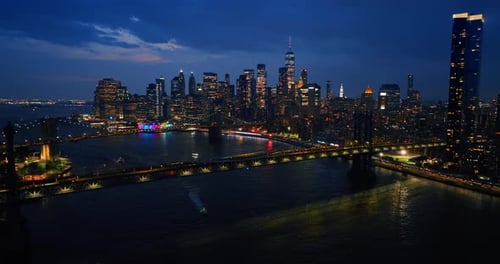 Beautifully illuminated bridges over the East River at night.