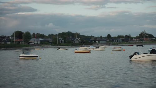 Boats Moored in Harbor on Cloudy Day