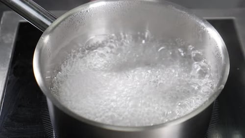 Clean Boiling Water in Pan Slow Motion Footage Shot in Real Restaurant Kitchen Bubbles and Steam