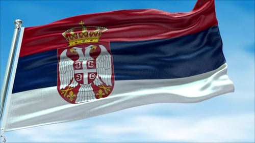 Realistic Waving Flag of Serbia Against Blue Sky
