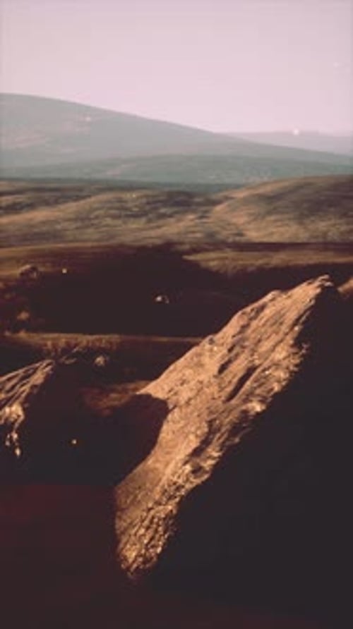 Large Rock Standing in Field