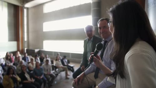 Audience Listening to Panel Discussion at Conference