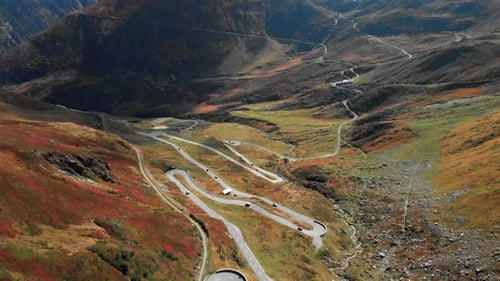 Drone aerial view of windy roads in countryside of Switzerland. Colorful landscape and Swiss Alps mo