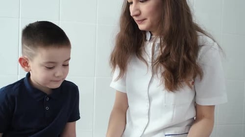 the doctor asks the child what is drawn in the notebook
