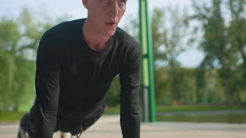 Trainer Performing Highintensity Pushups Outdoors Man Executing Vigorous Push Movements at Park