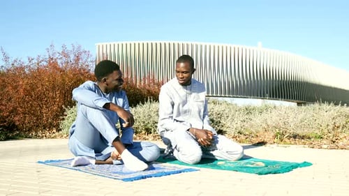 Young Men Talking, Sitting on Prayer Rugs
