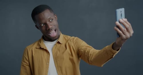 Man Taking Selfie with Cell Phone Indoors