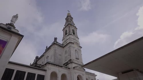 Exterior of Church Tower Against Cloudy Sky
