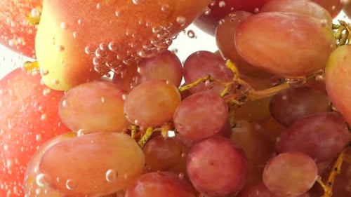 Background with fruits and berries in water with air bubbles.
