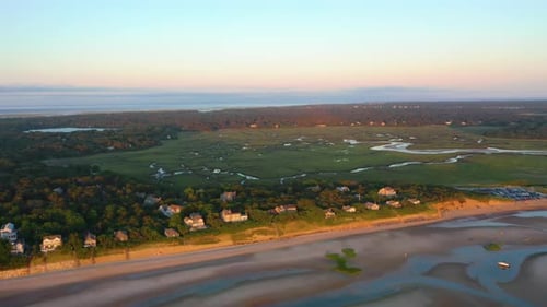 Cape Cod Bay Aerial Drone Footage of Beach Front Houses and Marsh at Low Tide During Golden Hour wit