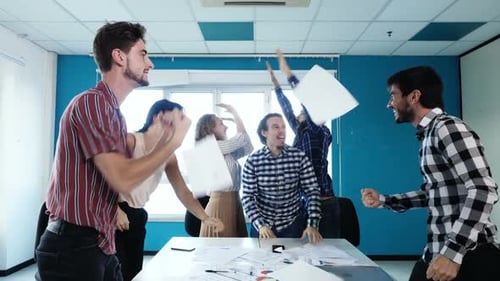 Diverse Team Celebrates Success in Modern Office