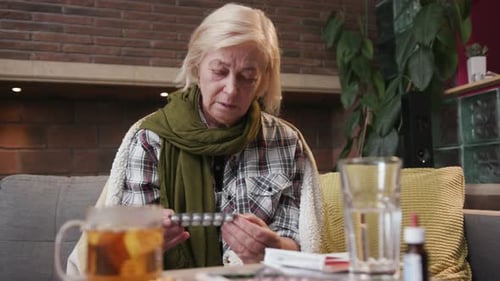 Senior Woman Reads Medication Instructions in Living Room
