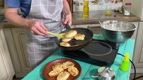 Frying Pancakes in a Skillet at Home