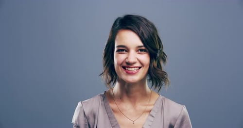 Smiling Woman Makes Heart Shape with Hands