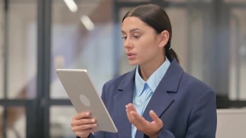 Woman in Suit Having Video Call on Tablet