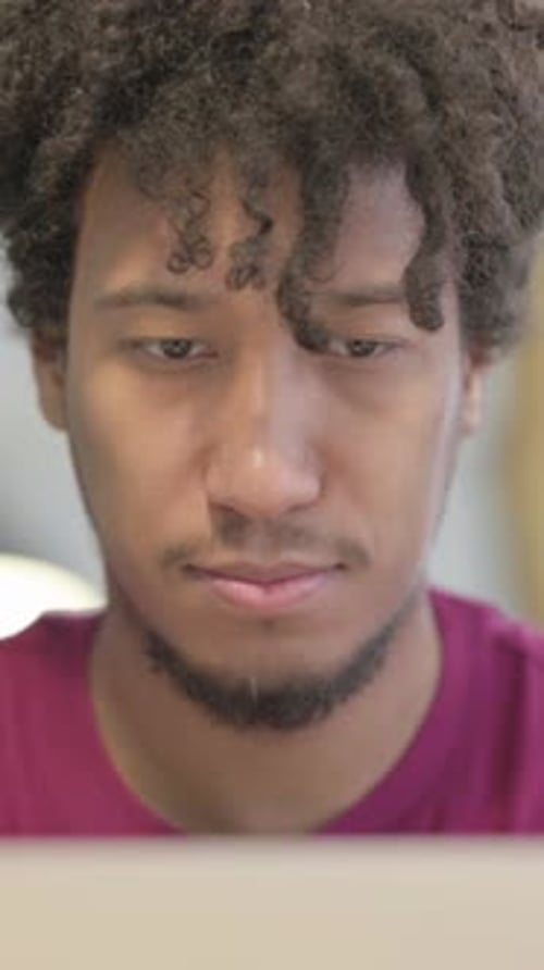 Close Up of African Man Typing on Laptop in Office, Vertical Video