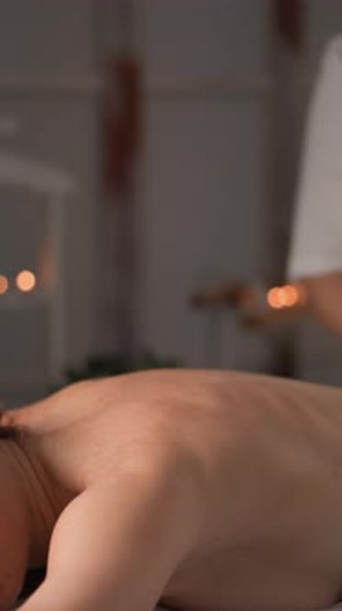 Massage Therapist Massaging Client's Back Indoors