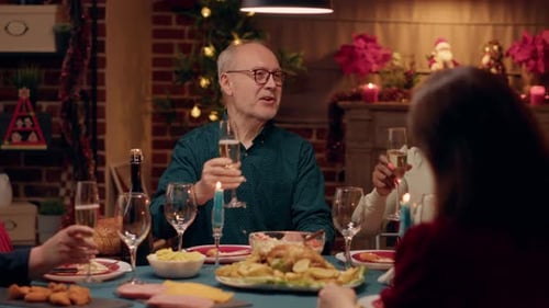 Adults Toasting Champagne at Christmas Dinner