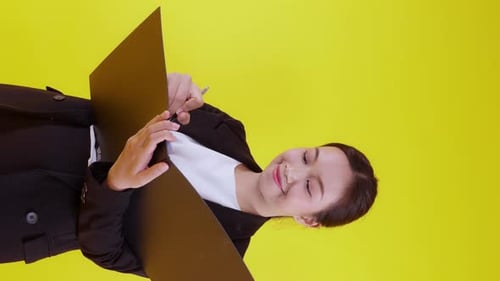 Portrait young asian businesswoman hold folder and writing record document with success.