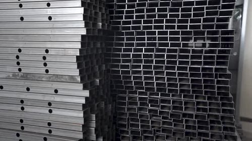 Metal pipes. Close view profile pipe laid in rows.