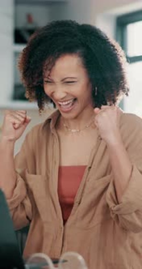 Smiling Woman Celebrates Success at Home