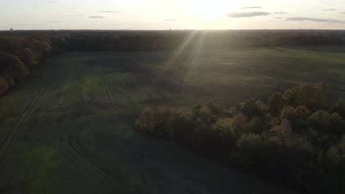 Smooth 4k drone flight at a beautiful sunset on a warm autumn day.
The field is green and the sky is