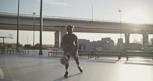 Young Adult Playing Basketball on Urban Court