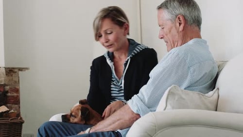 Loving Senior Couple Relaxing with Their Dog
