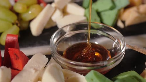 Delicious Cheese and Grapes with Honey Close Up