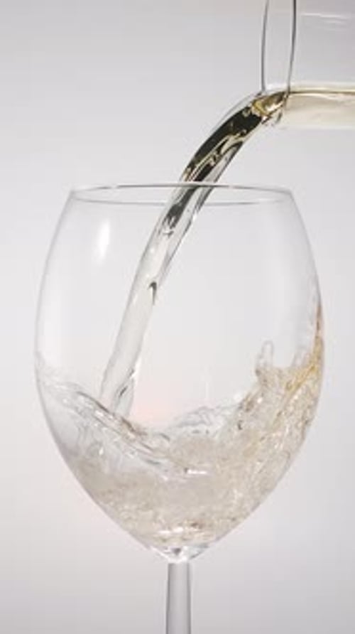 White Wine being Poured into Wine Glass