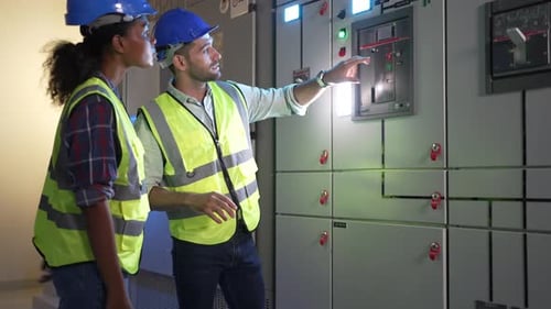 Engineers are checking electronic system at basement.